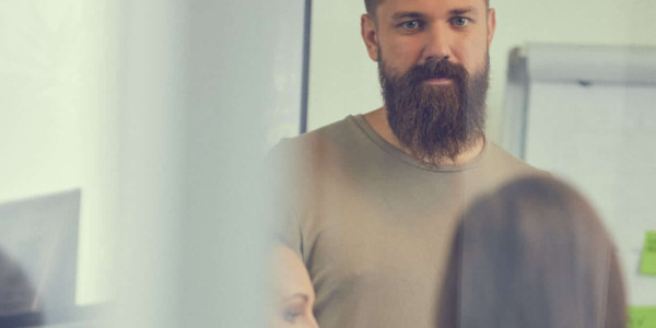 CUBE CTO Andris standing with coffee mug