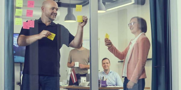 Workshop with post-it notes on the glass wall