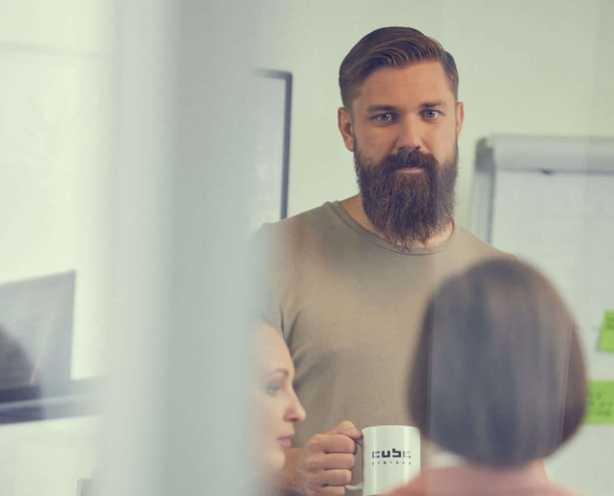 CUBE CTO Andris standing with coffee mug