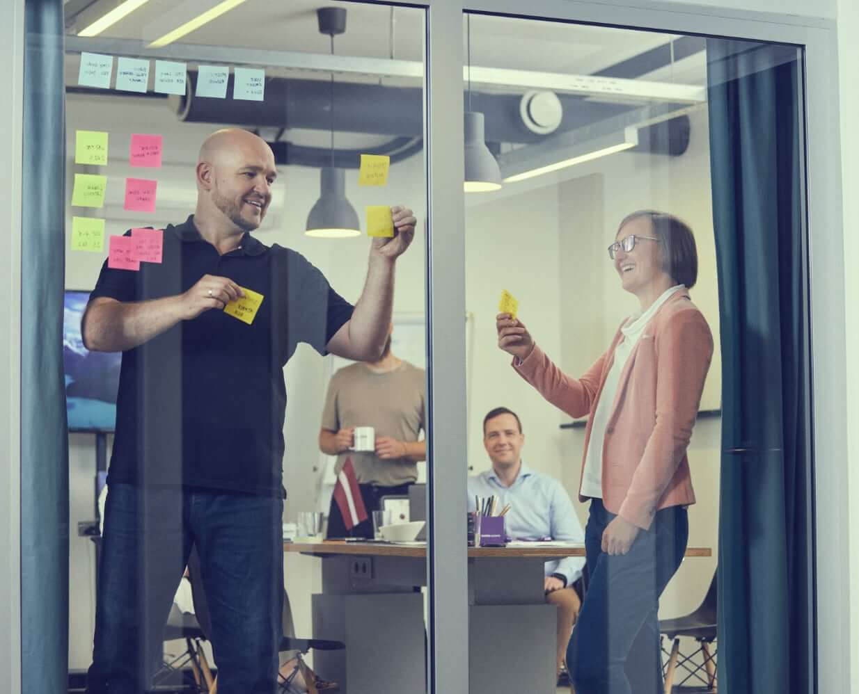 Workshop with post-it notes on the glass wall